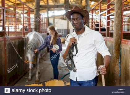 portrait-of-mature-afro-man-farm-worker-standing-at-horse-stable-RH8213.jpg